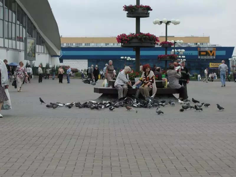 Menschen auf dem Platz vor der Markthalle Kamarowka in Minsk